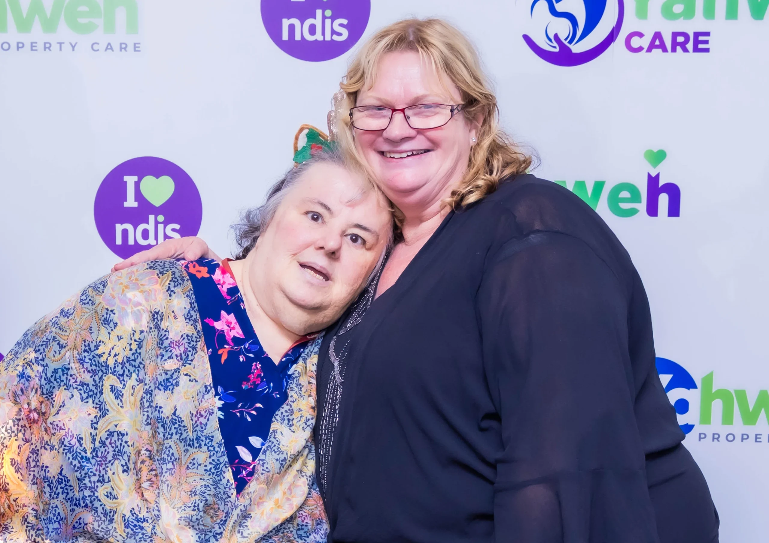 An NDIS participant and a Yahweh Care staff member in a warm embrace, symbolising the personalised and supportive care provided