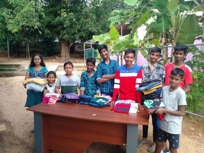 A group of individuals receiving a variety of clothing items