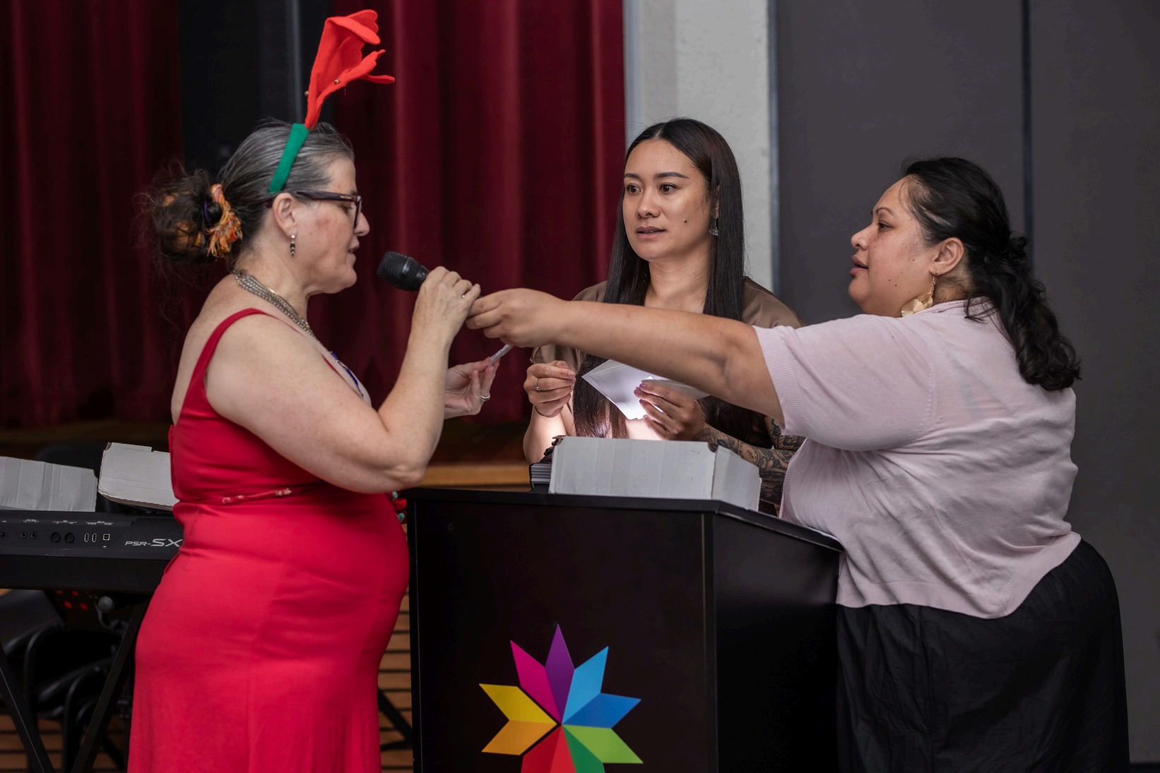 A family moment captured at a Yahweh Care event, with an adult holding two children